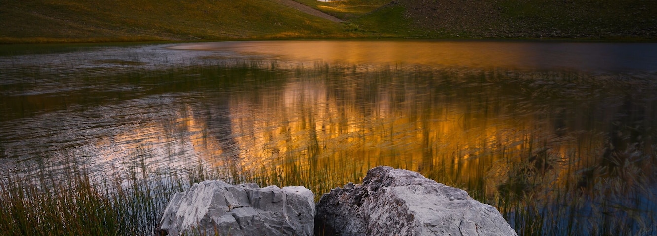 Golden sunlight hitting the peaks above the dragon lake in northern Greece. It's a moderately steep hike of about 3 hours to the refuge (where you can sleep and order food) and then another hour to this lake. We had the place to ourselves the entire evening. It was magical! #golden
