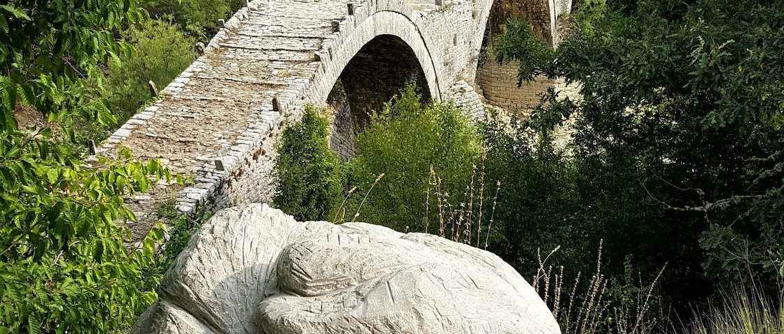 My husband and I traveled through Greece by motorcycle, and we explored different historic sites. This region in Greece has a series of stone bridges that were built during the Ottoman Empire! This is an unique one because has three arches.