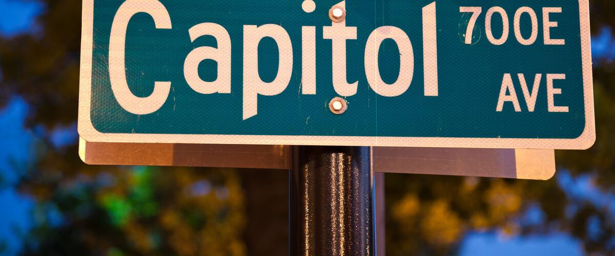 A street sign for Capitol 700E Ave.
