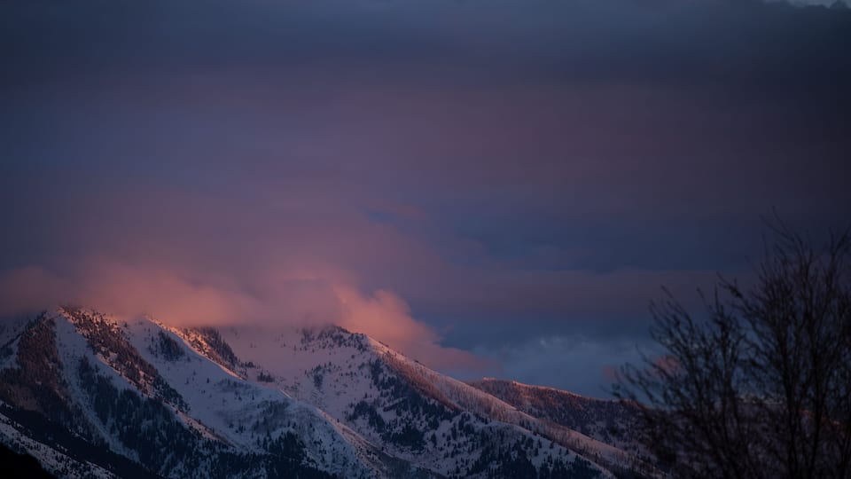 Snow-covered mountains under a twilight sky.
