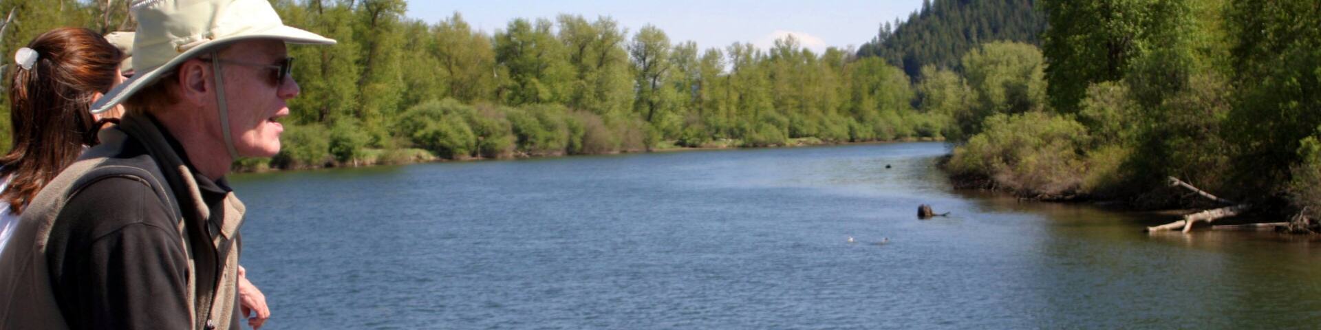 St. Maries which includes a river or creek and forest scenes as well as a small group of people