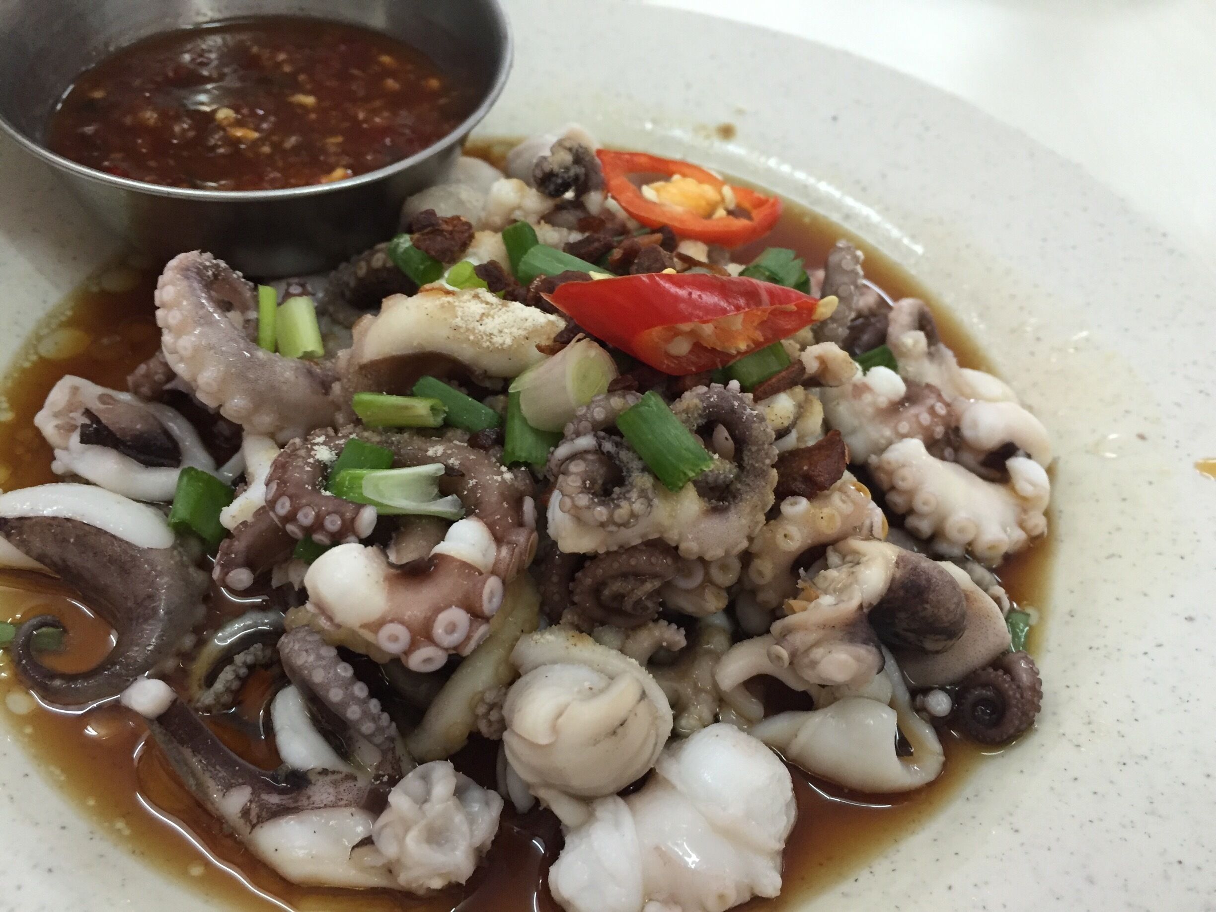 If calamari is your thing then head out to this Chinese restaurant. Poached baby squids in soy sauce with chili dip. This is the only dish I found appealing. Serves many other dishes as well. Give it a try. 