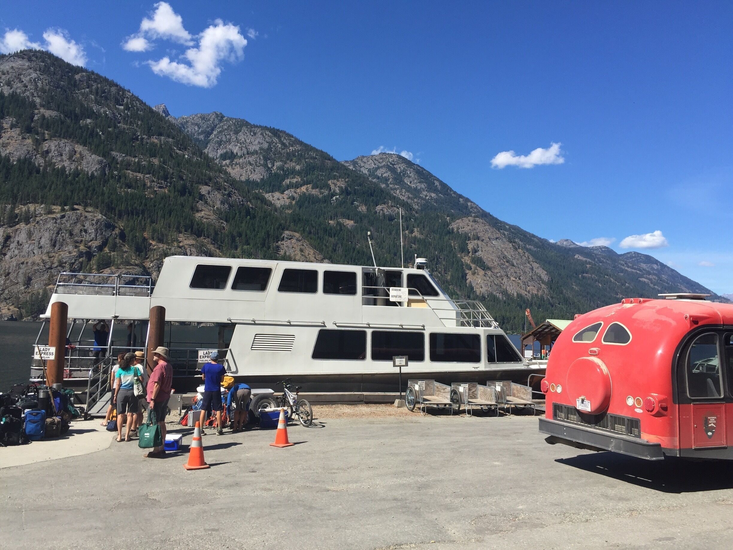The Lady Express passenger boat is docked for an hour layover at Stehekin after a fifty-five mile journey to the head of Lake Chelan. A North Cascades National Park bus provides transportation to the park nine miles away. No roads lead to Stehekin.