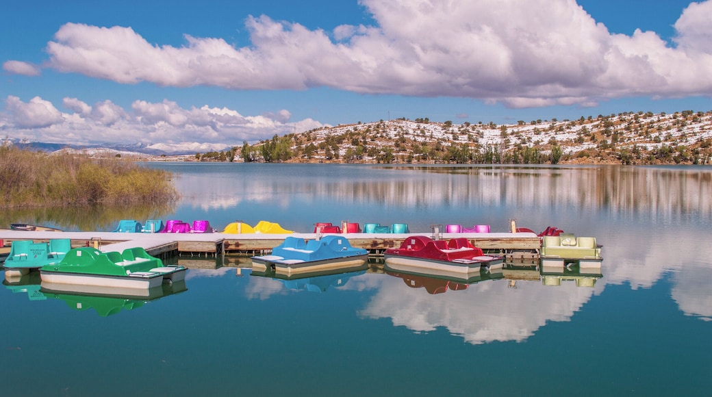 Colorful paddleboats on crystal blue Palisade Lake in Paslisade State Park. We were there in May of 2014, and woke up on Mother's Day to a surprise 9 inches of snow! It had mostly melted by the next day but still provided a pretty contrast to the bright blue sky. This state park offers fishing, camping, golfing, OHV trails, and boat rentals. #utah #palisadelake #snow #lake