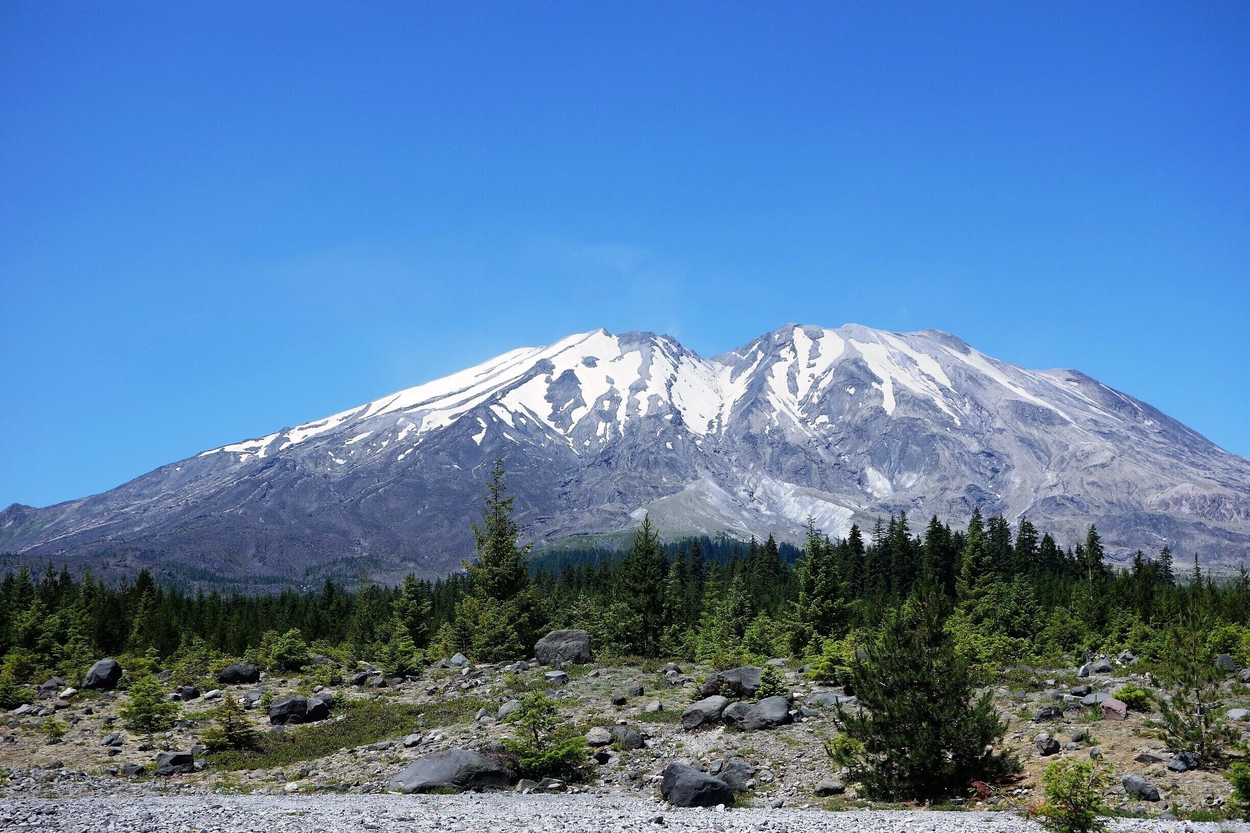 A snow-capped mountain with a clear blue sky.