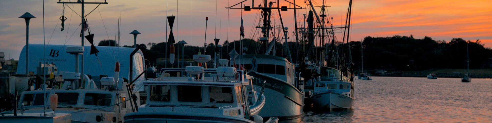 Stonington showing a sunset and a bay or harbor