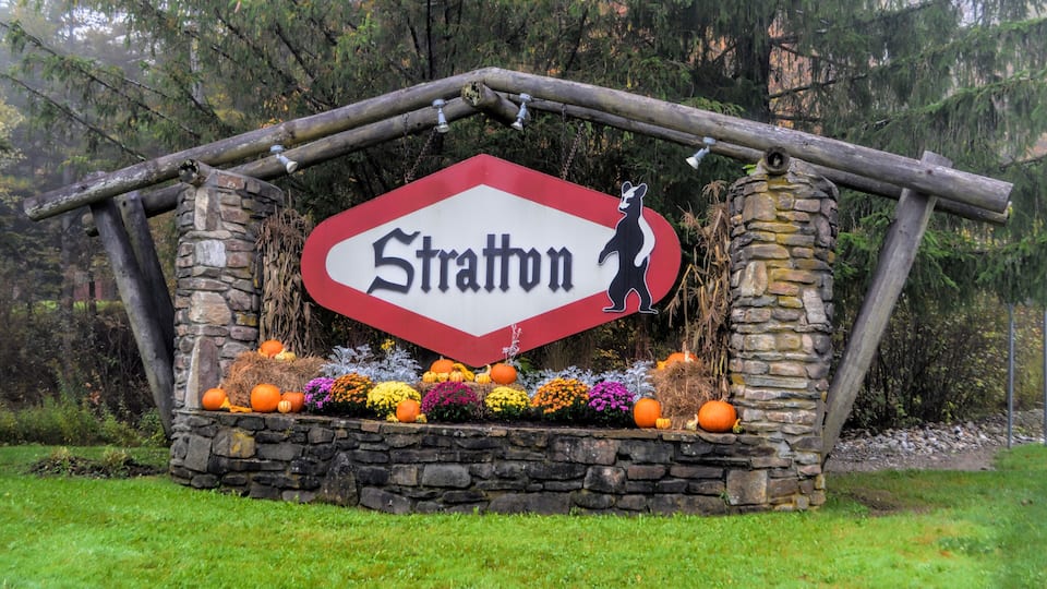 A stone structure with a red and white sign reading 'Stratton' and a bear silhouette.