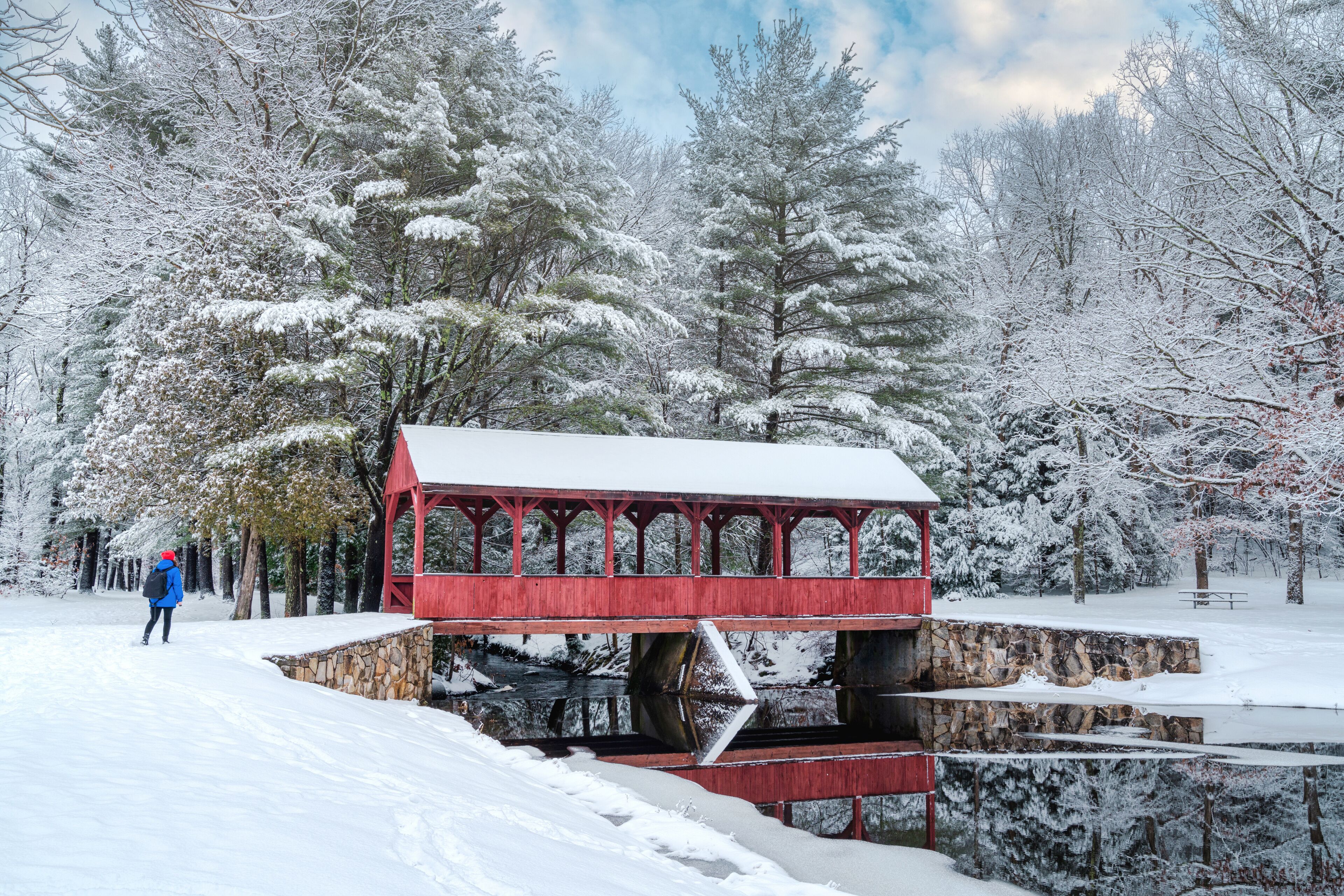Hiker walking in Stratton state park in the snow