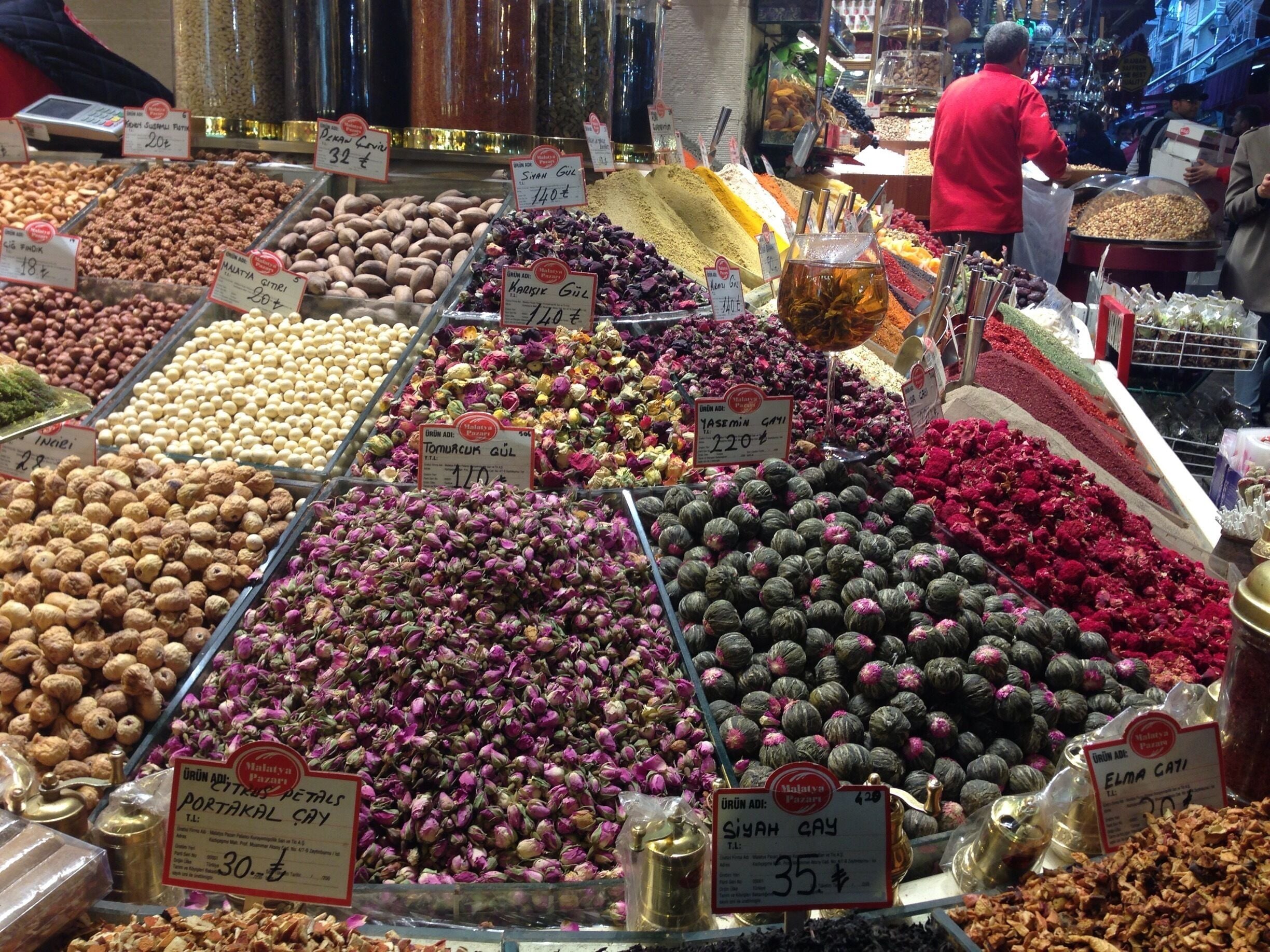 A market with various nuts and dried flowers on display.
