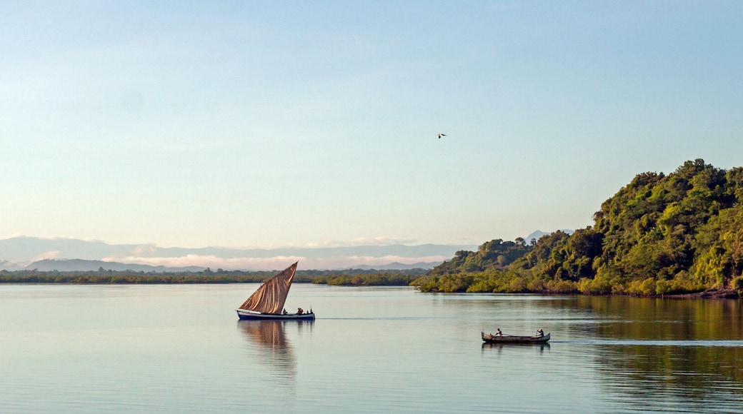 Nosy Be, Madagascar: traditional sailing boat and canoe sail out on the Indian Ocean from Port Ankify, Ambanja district, Northern Madagascar.