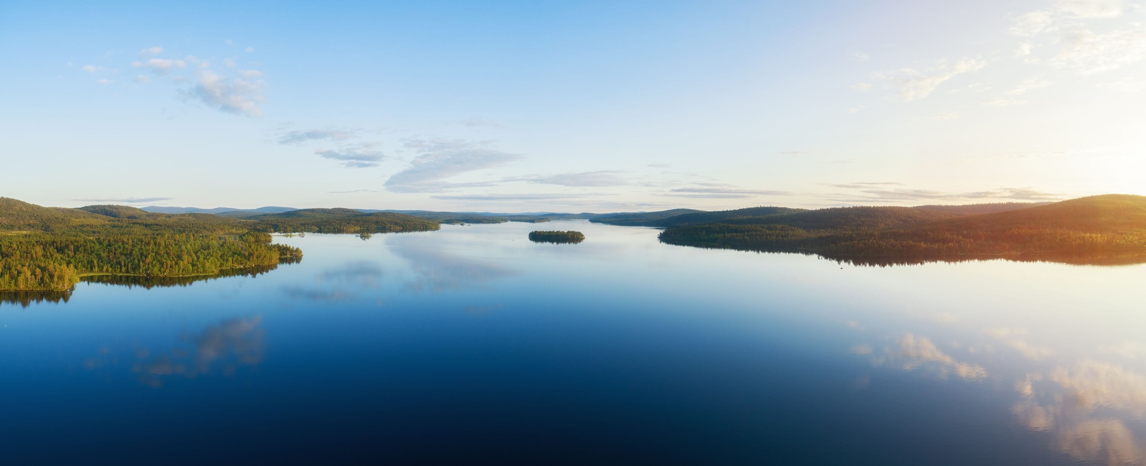 Aerial panorama of beautiful lake Inari, islands and green forest at sunset. Inarijarvi,Lapland