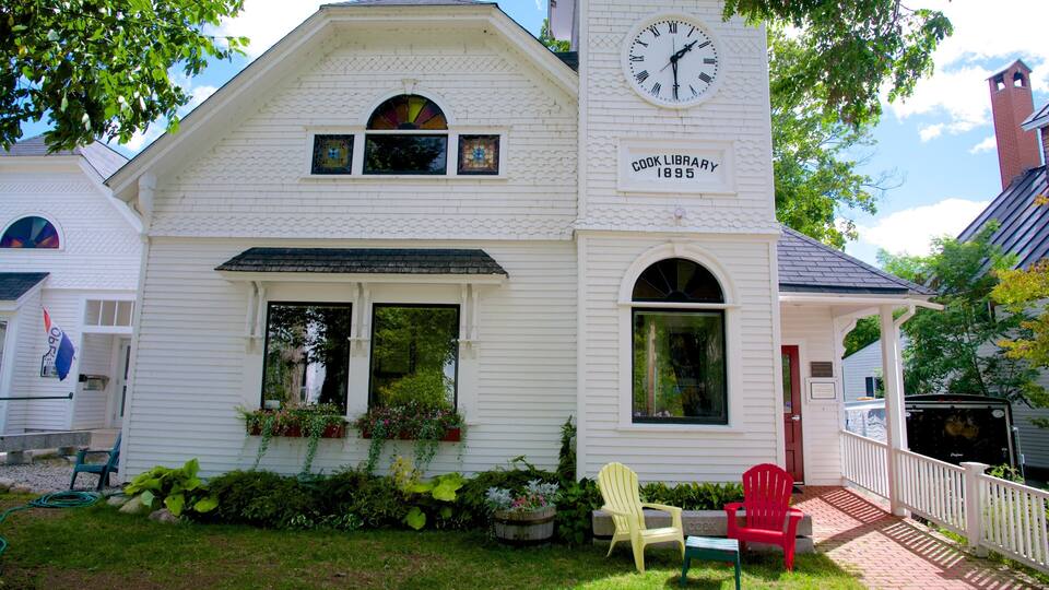A white building with a clock and the words "COOK LIBRARY 1895" on the side.