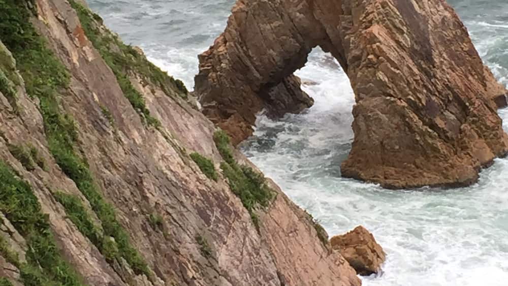 This is part of the Sanin Kaigan National Park in Japan. It is known as the Senganmatsu Island where a pine tree can be found on it!
Wikipedia:
The Uradome Coast is made up of rocks formed by marine erosion, white sandy beaches, and dense scrub pines. The coast stretches for approximately 15 kilometers (9.3 mi) to 16 kilometers (9.9 mi) along the Japan Sea on the eastern tip of Tottori Prefecture from Cape Kugami to Mount Shichiyama. Marine erosion has formed distinctive natural sea walls, cliffs, tunnels, caves, and large rocks of unusual shapes. The Uradome Coast is an important part of the Sanin Kaigan National Park.
The Uradome Coast is known as the "San'in Matsushima" due to its resemblance to Matsushima in Miyagi Prefecture. The author TĆson Shimazaki (1872â1943) was especially fond of the Uradome Coast. He praised the area with the quote "Matsushima is Matsushima, Uradome is Uradome".
The name of the Uradome Coast in Japanese is formed from two kanji. The first, 攊, means "inlet" and the second, ćŻ means "abundant" or "rich".