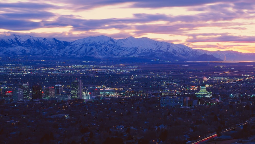 A cityscape with a mountain range in the background.