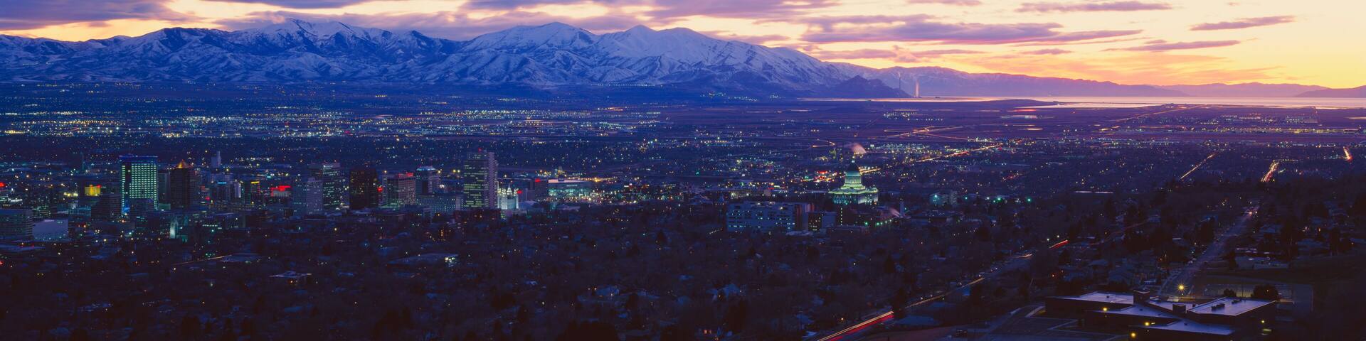 A cityscape with a mountain range in the background.