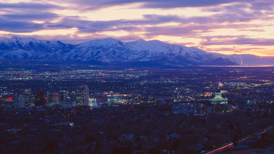 A cityscape with a mountain range in the background.