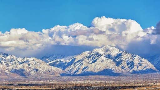 Winter Panoramic view of Snow capped Wasatch Front Rocky Mountains, Great Salt Lake Valley and Cloudscape from the Bacchus Highway. Utah, USA.