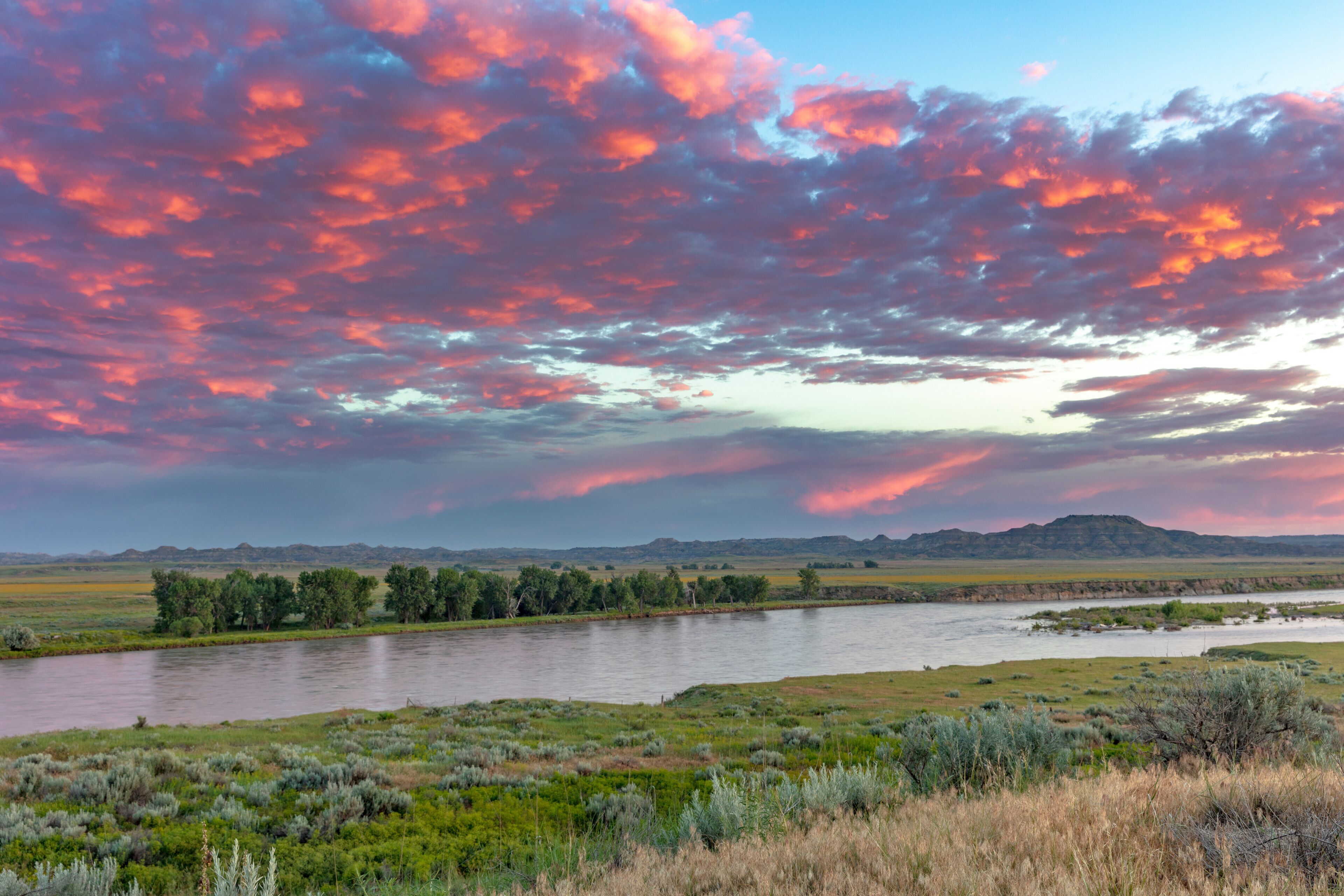 Sunrise and clouds over the Yellowstone River at the confluence with the Powder River near Terry, Montana, USA