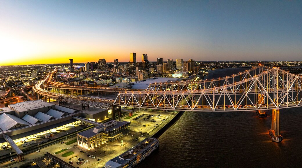 Aerial view of the scenic skyline with the twinkling lights of the city and the Mississippi River under twilight, Gretna, USA.