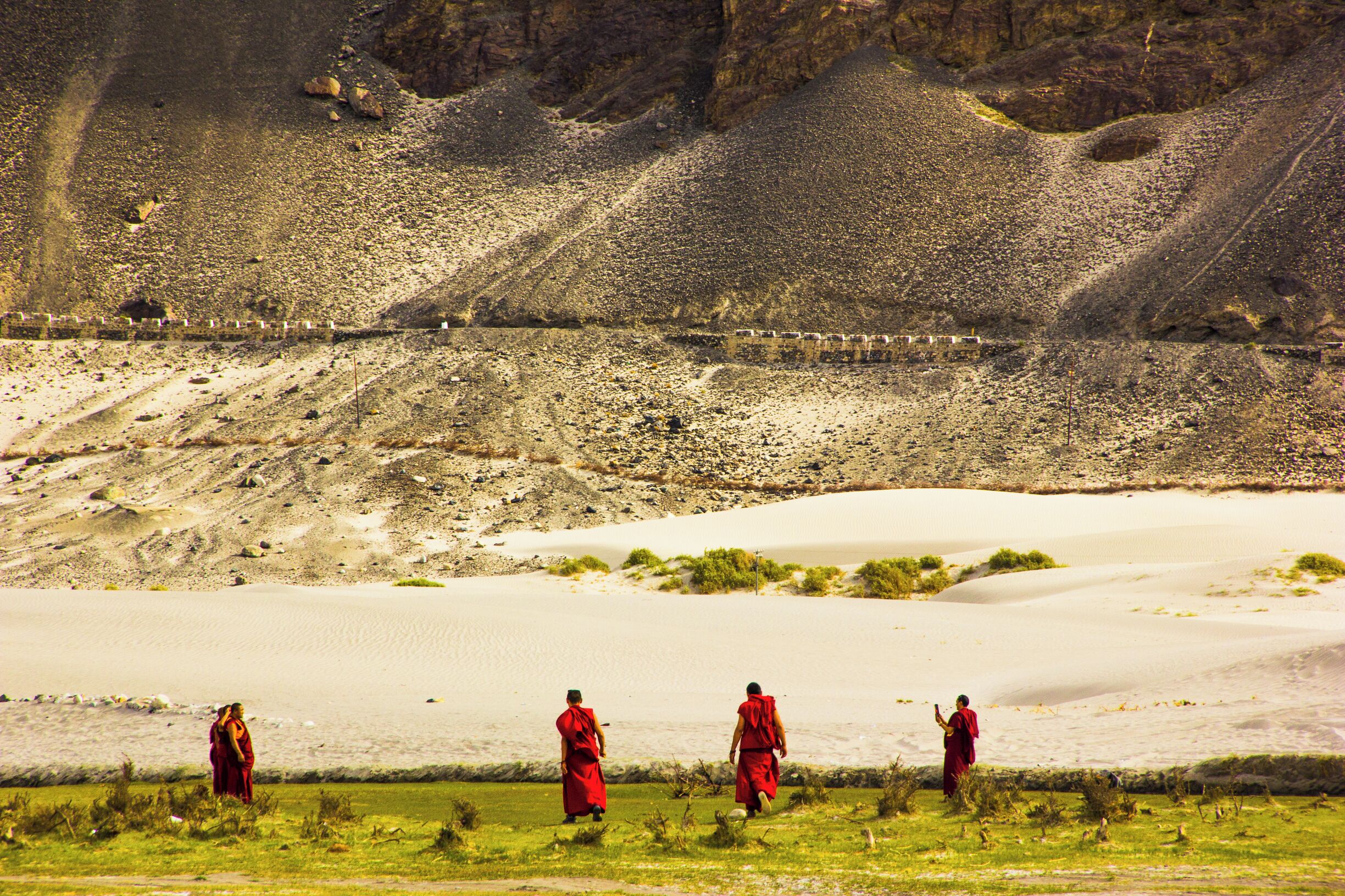 It is no secret that Ladakh is both a traveler and photographer's dream. After first few days of clicking out of frenzied excitement, we realized to better wait for surreal moments like this to enjoy the journey. Now does this often happen to you?

Pictured here: the monks at Nubra Valley calling it a day. Yep this was clicked around sunset. 🇮🇳😍