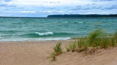 a stunning view across the turquoise-colored water of lake michigan from the beach at sleeping bear point in sleeping bear dunes national lakeshore in the lower peninsula of michigan