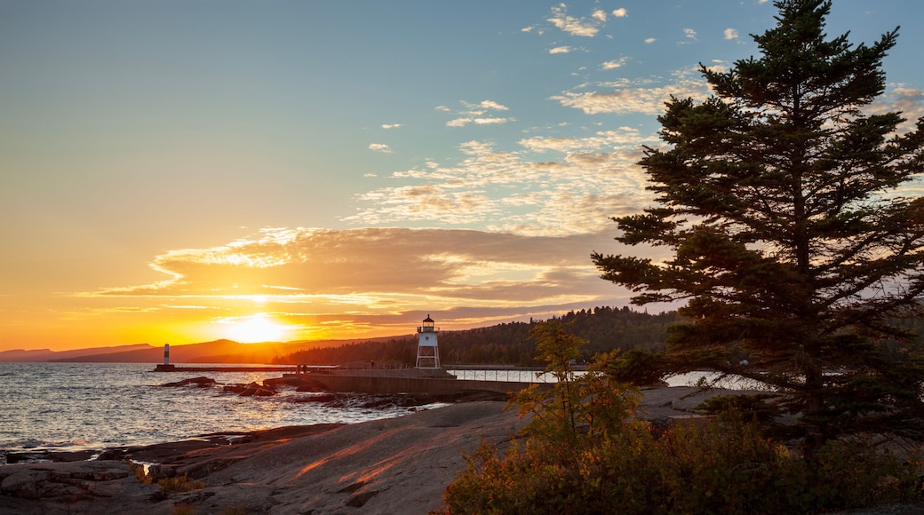 Sunset at Artist's Point with the lighthouse and Lake Superior in Grand Marais Minnesota