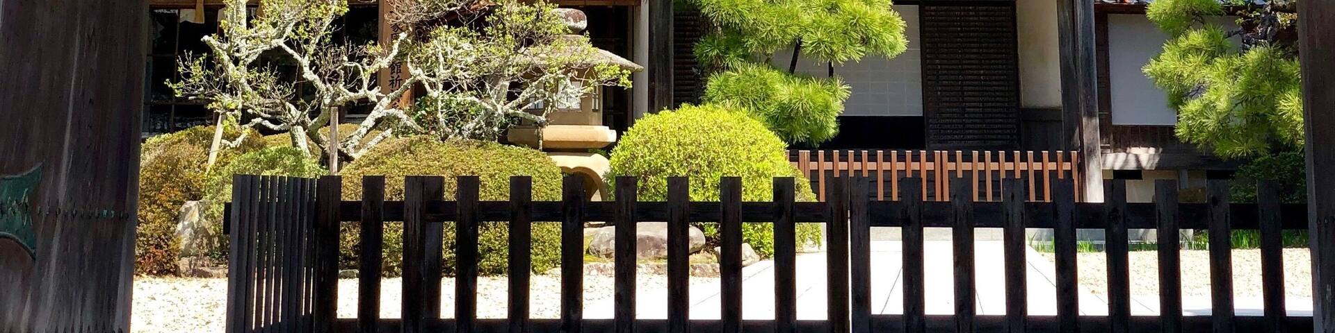 A traditional Japanese building with a thatched roof and wooden beams.
