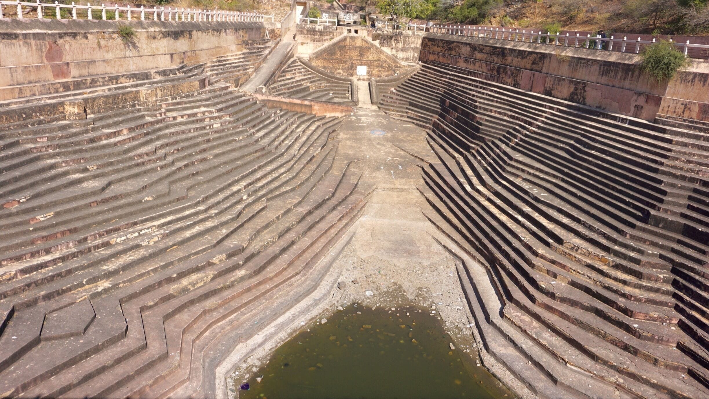Falling for Stepwell yet again!
.
.
Stepwell always has a story woven to it. The descending set of steps of The Nahargarh Stepwell leads to the groundwater which in olden days was the main source of water during summers. The steps give an image of waves rolling downwards from the hills. This particular one was built in such a way that it will collect the water from the hill side of the fort. Even today, the Stepwell is known for its brilliant design and usefulness. That’s the beauty of an old world charm, isn’t it?