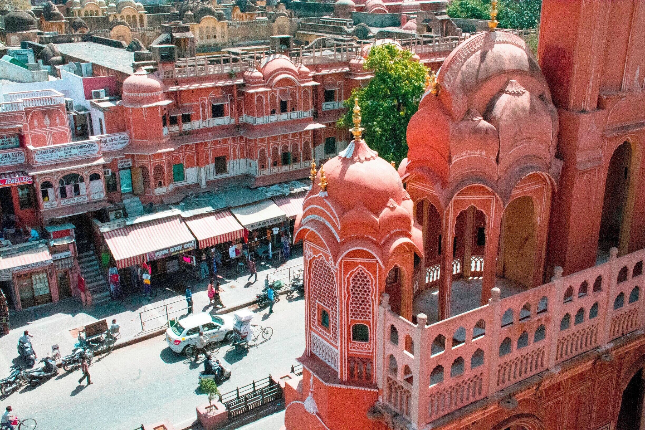 The Hawa Mahal, or "Palace of the Winds" in the foreground, was constructed in the late 18th century by the Maharaja Sawai Pratap Singh so that the ladies of royal household could watch processions on the street below without being seen from the outside.