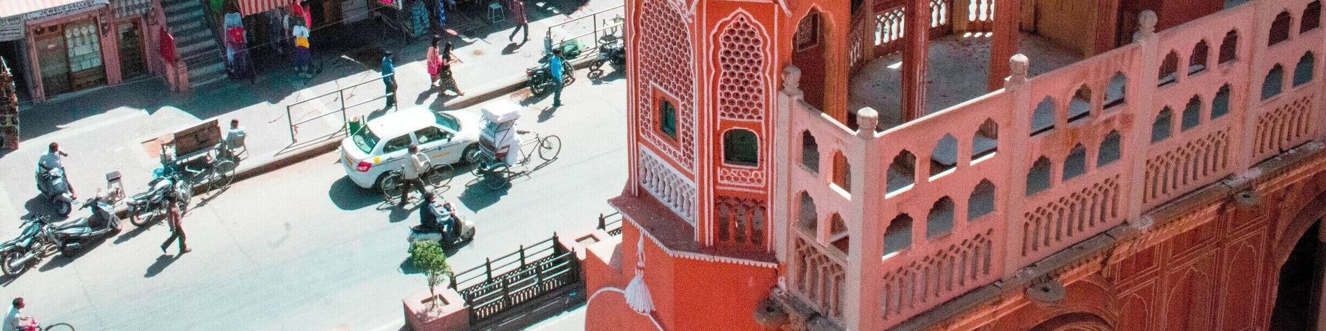 The Hawa Mahal, or "Palace of the Winds" in the foreground, was constructed in the late 18th century by the Maharaja Sawai Pratap Singh so that the ladies of royal household could watch processions on the street below without being seen from the outside.