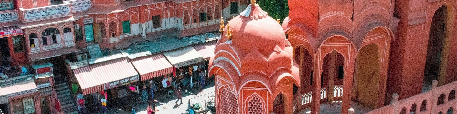 The Hawa Mahal, or "Palace of the Winds" in the foreground, was constructed in the late 18th century by the Maharaja Sawai Pratap Singh so that the ladies of royal household could watch processions on the street below without being seen from the outside.