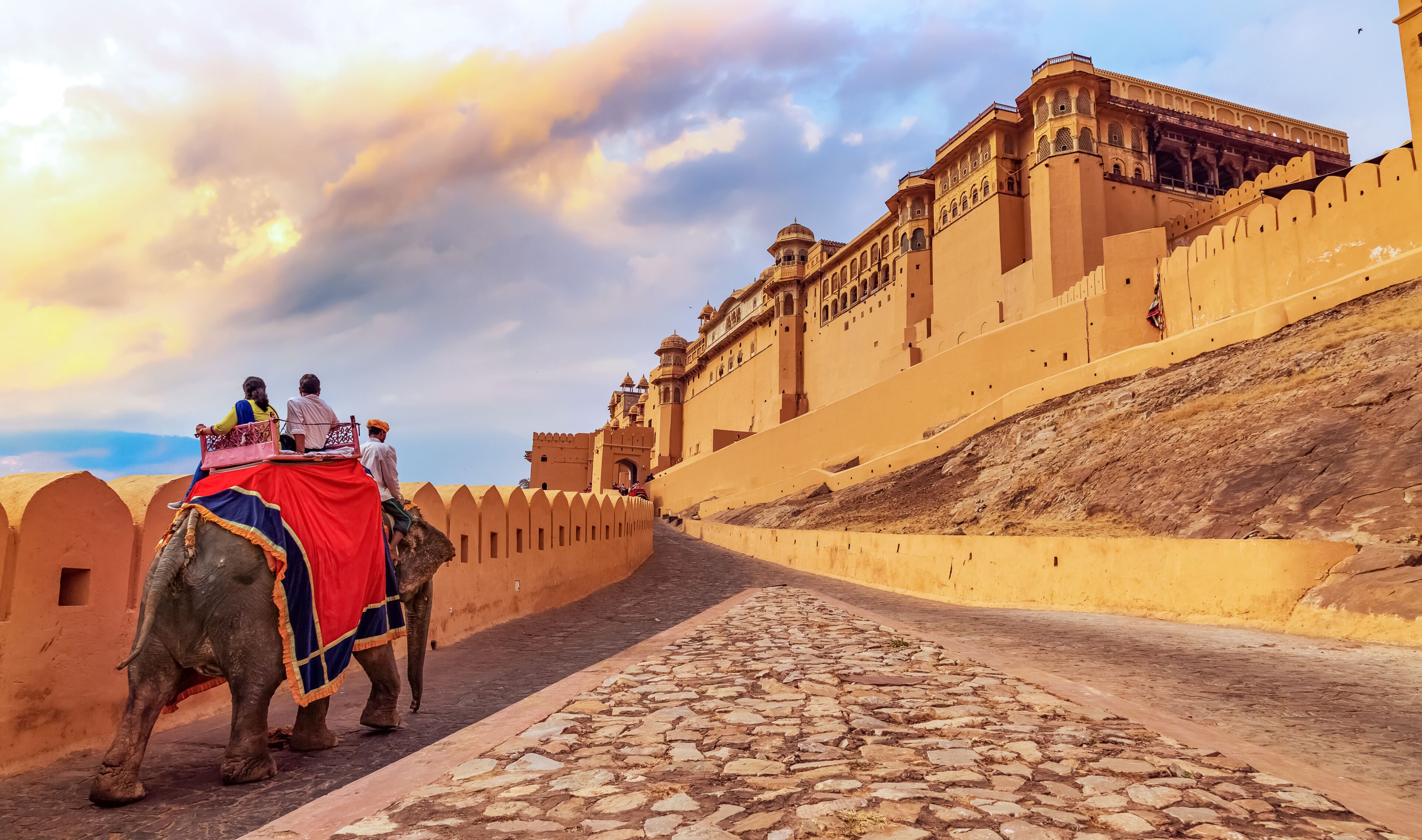Amer Fort Jaipur - Tourists enjoy elephant ride at sunrise