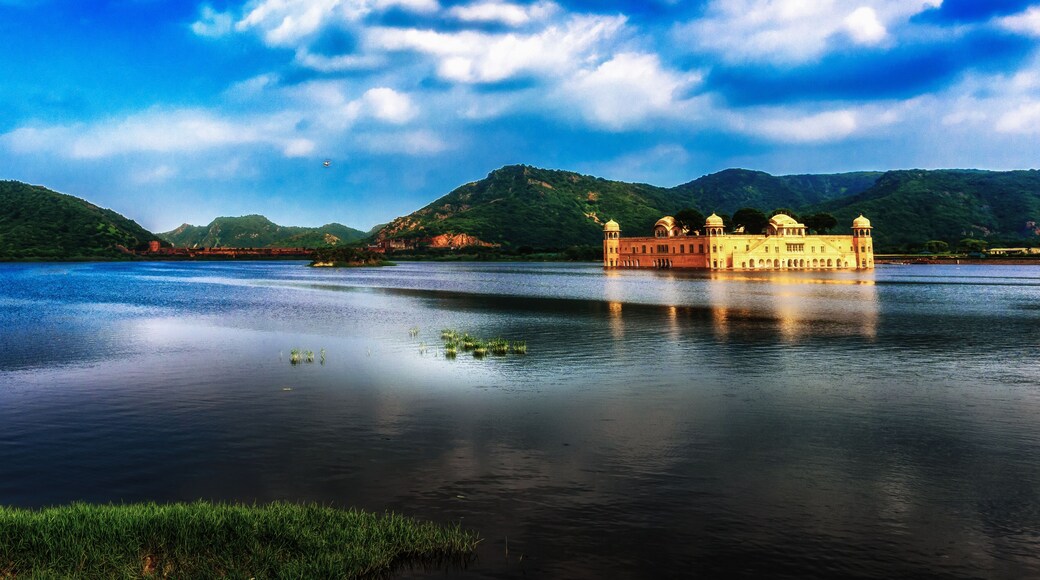 A panoramic view of the Jal Mahal of Jaipur on the blue water under the monsoon clouds, India