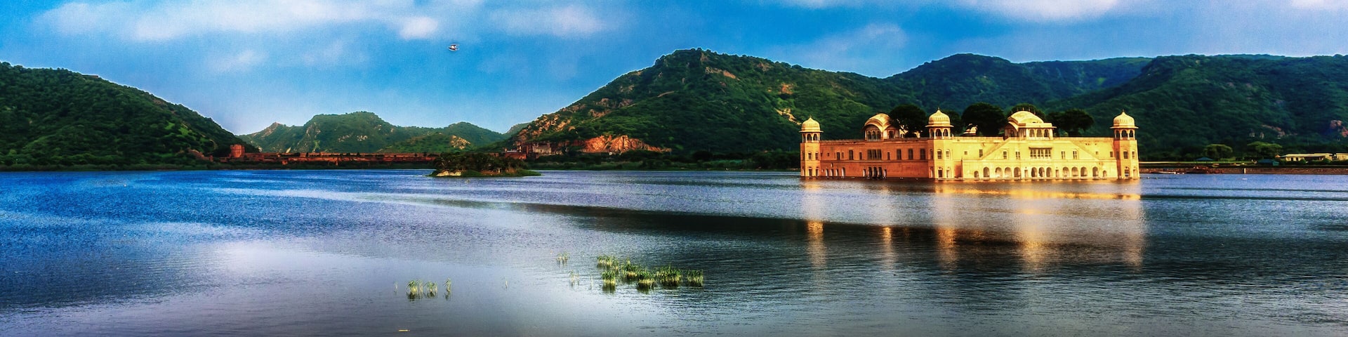 A panoramic view of the Jal Mahal of Jaipur on the blue water under the monsoon clouds, India