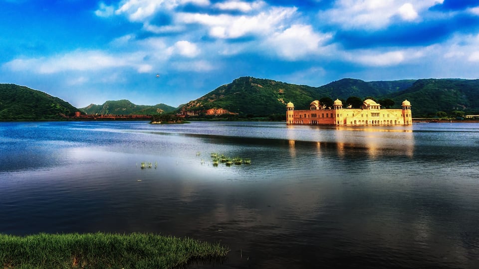 A panoramic view of the Jal Mahal of Jaipur on the blue water under the monsoon clouds, India