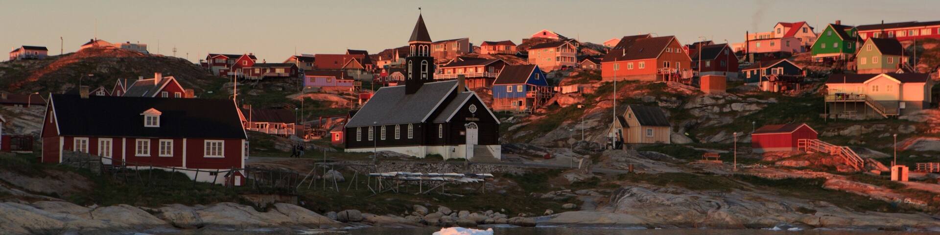 Ilulissat featuring a sunset, a lake or waterhole and a city