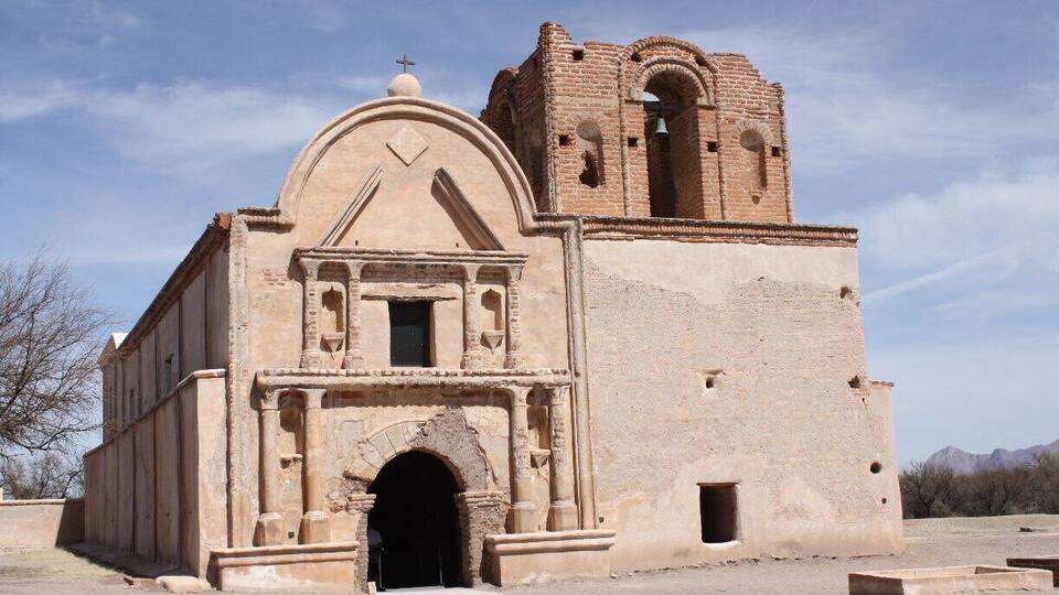 A historic church with a bell tower and arched doorway.