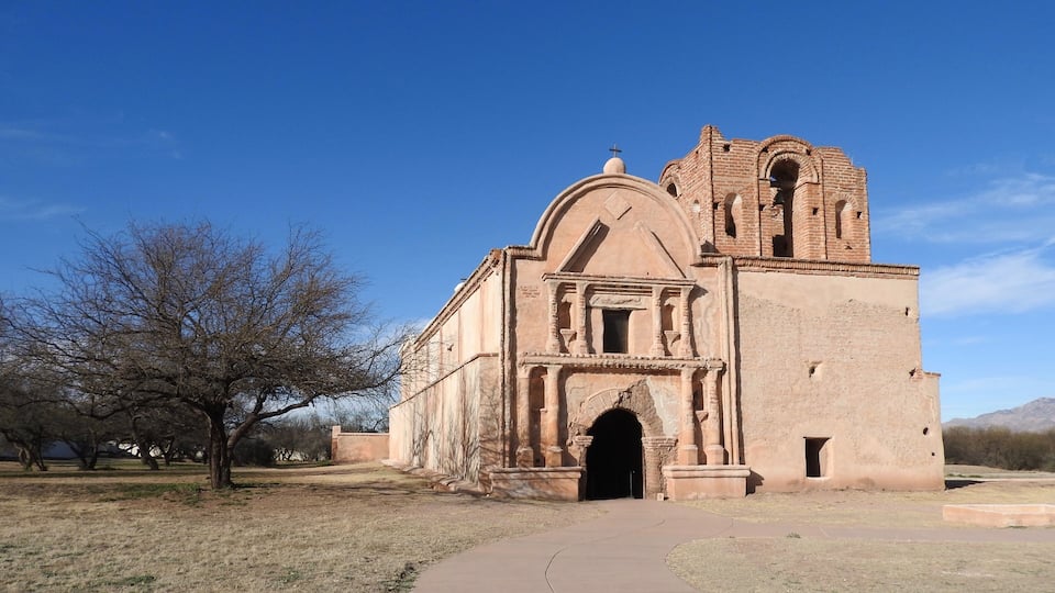 A historic church with a bell tower and arched entrance.