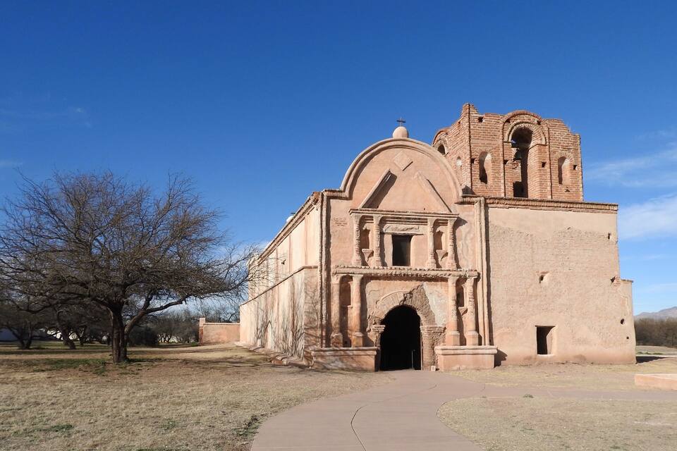 A historic church with a bell tower and arched entrance.