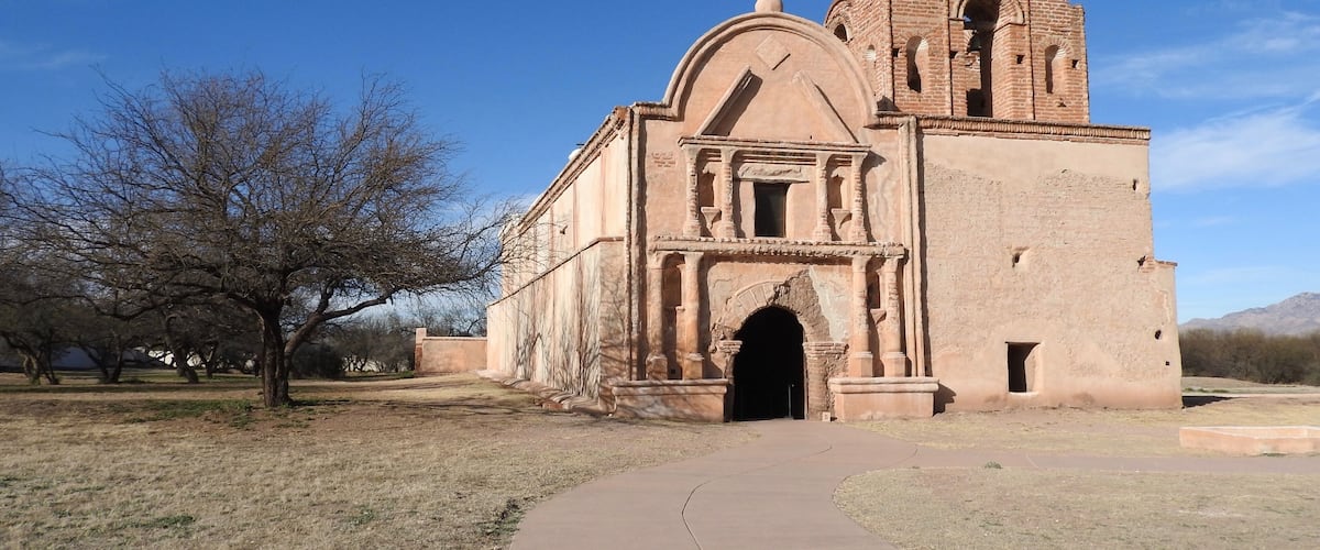 A historic church with a bell tower and arched entrance.