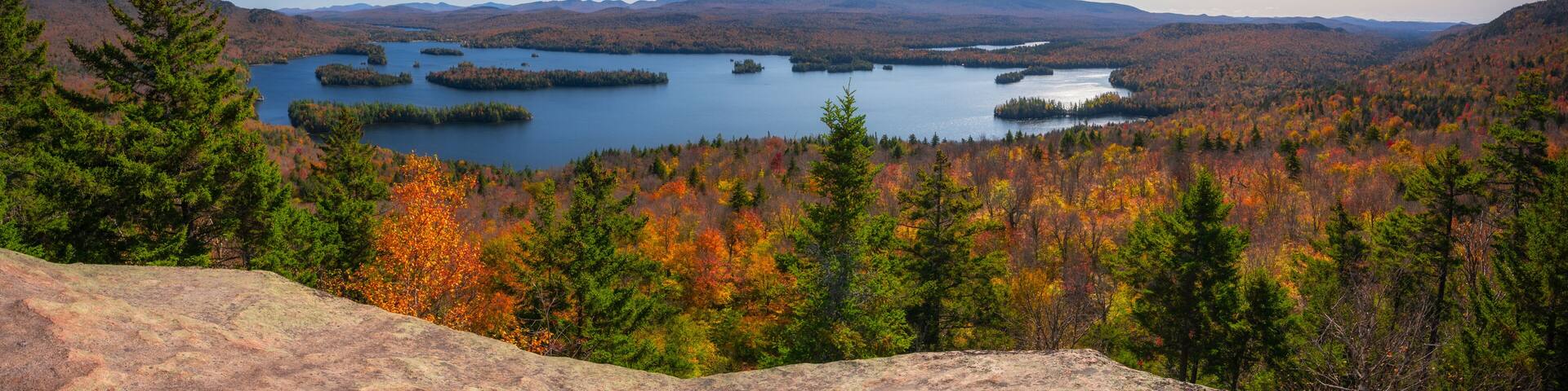 Panorama of the fall foliage and Tupper lake from Castle Rock summit in the Adirondacks New York