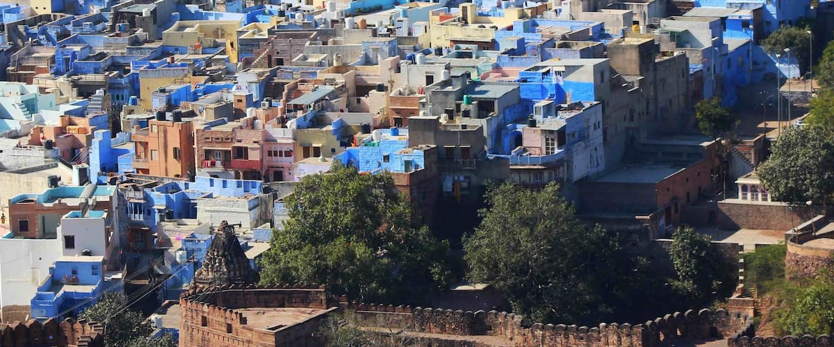 A densely packed urban area with numerous buildings painted in various shades of blue and beige.