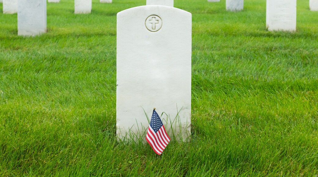 Headstones and Ameican flag in Arlington National Cemetery -Circa Washington D.C. United States of America