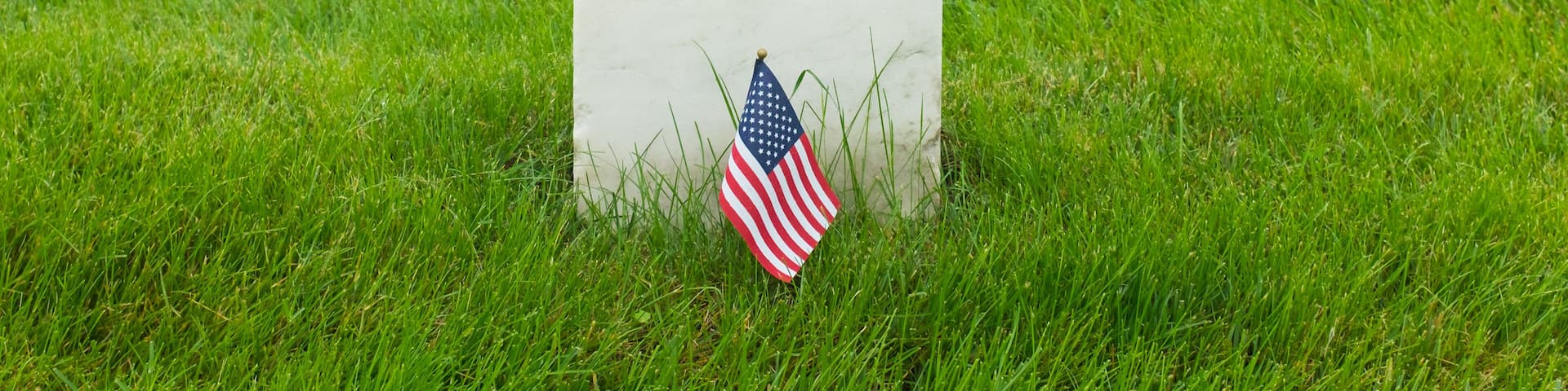 Headstones and Ameican flag in Arlington National Cemetery -Circa Washington D.C. United States of America