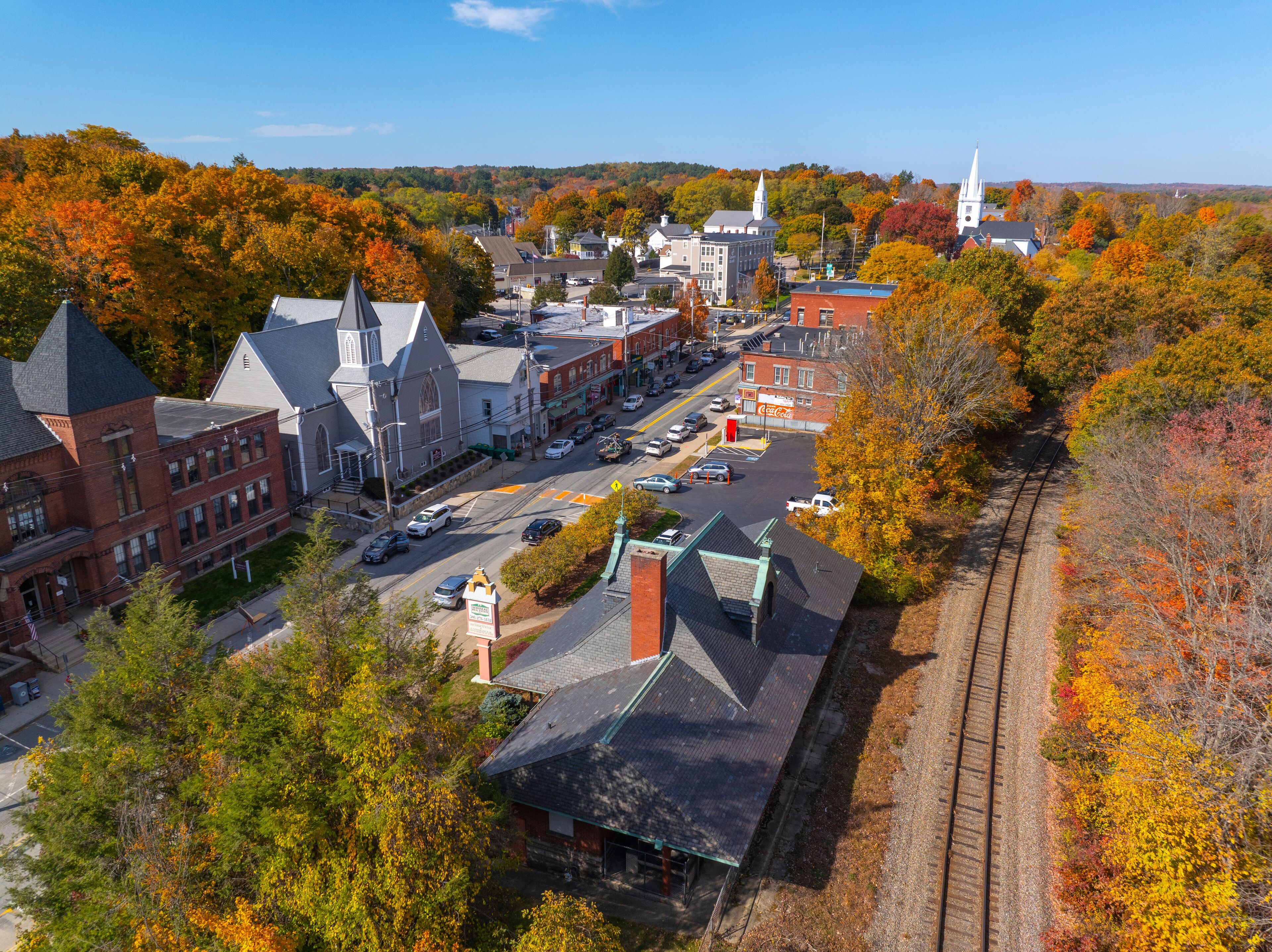 Uxbridge station aerial view in fall with fall foliage at 20 S Main Street in historic town center of Uxbridge, Massachusetts MA, USA. 