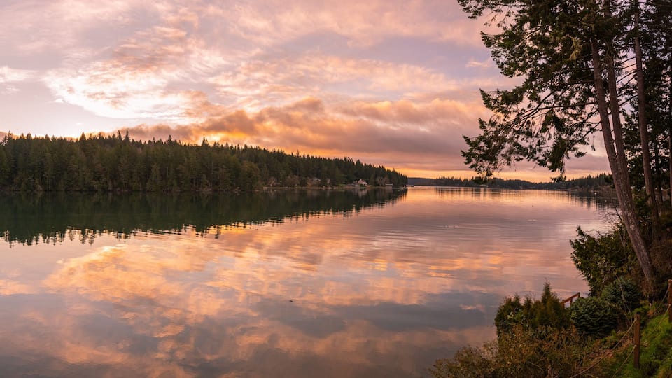 Panoramic landscape sunrise reflections on Filucy Bay, Puget Sound, Washington State Pacific Northwest