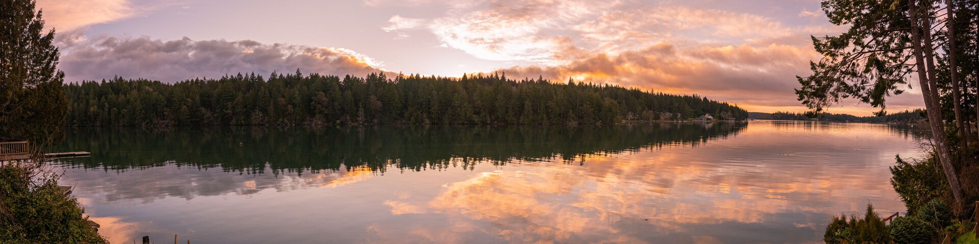 Panoramic landscape sunrise reflections on Filucy Bay, Puget Sound, Washington State Pacific Northwest
