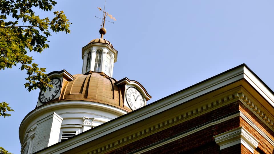 A building with a clock tower and a dome.