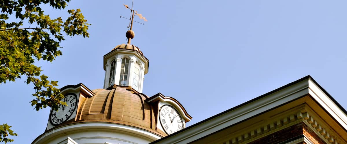 A building with a clock tower and a dome.