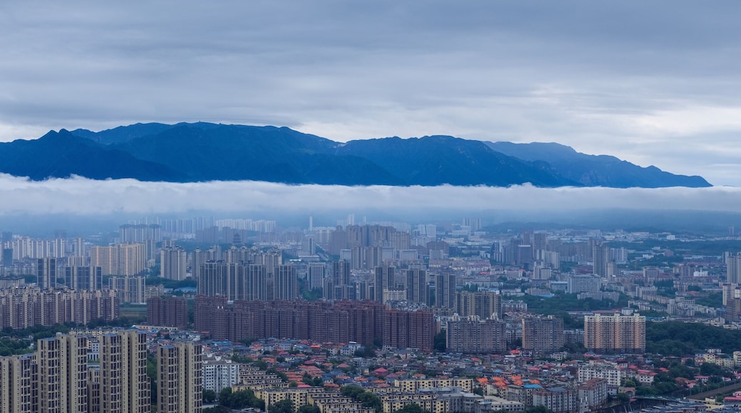 blue mountains on urban clouds and mist panorama